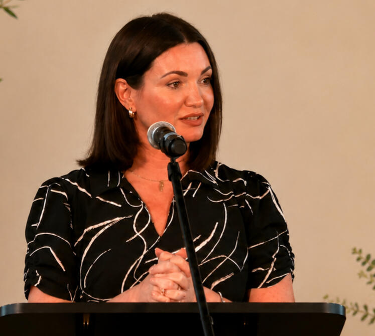 Image of Lauren Bear Hamilton at podium Lauren Bear Hamilton speaks at podium